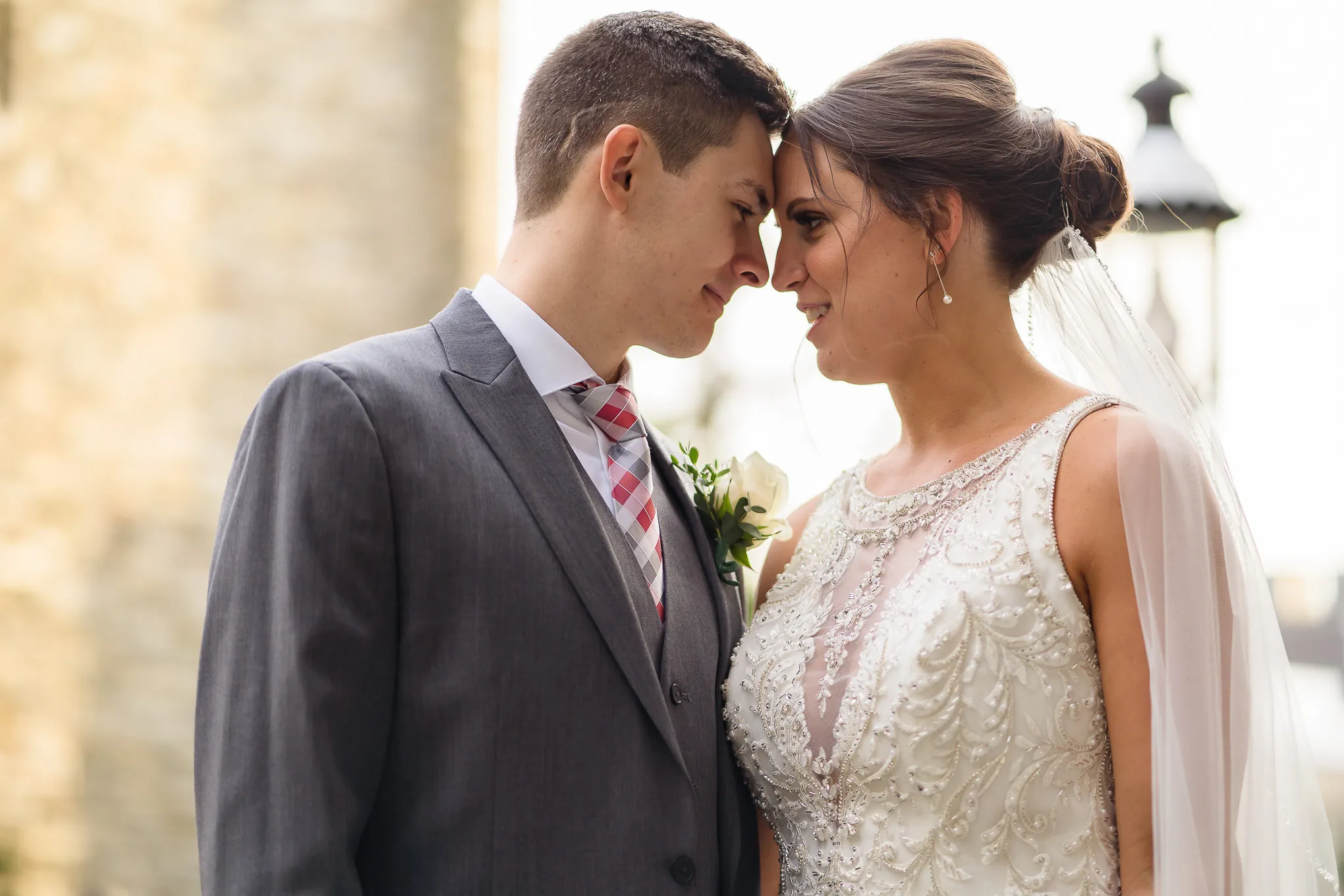 Bride and groom touching foreheads in golden light
