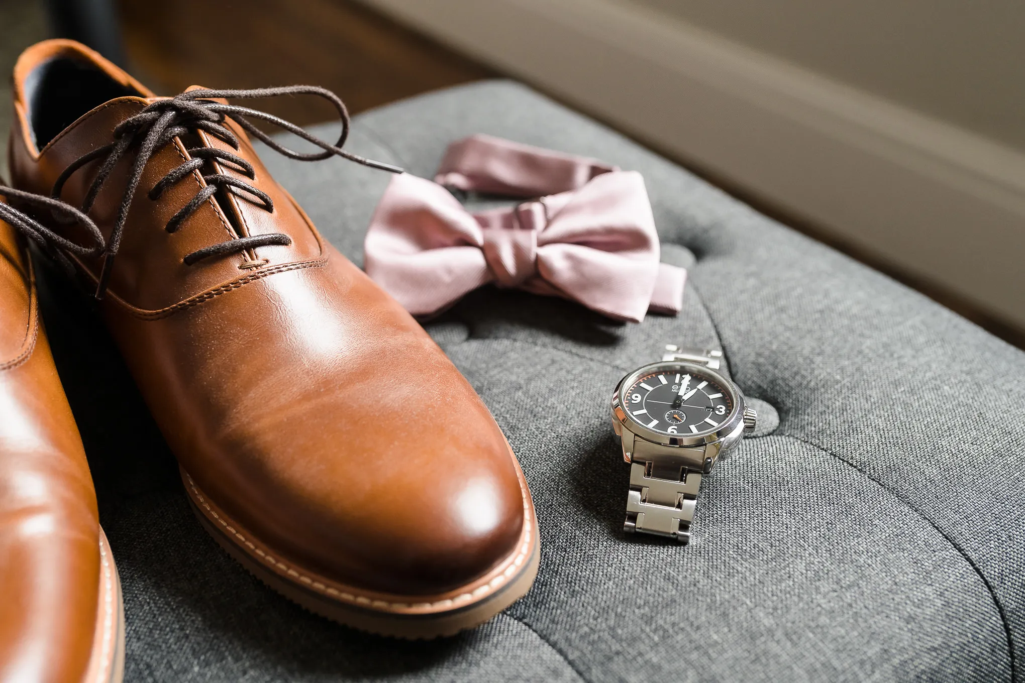 Groom's brown leather shoes, pink bow tie and watch