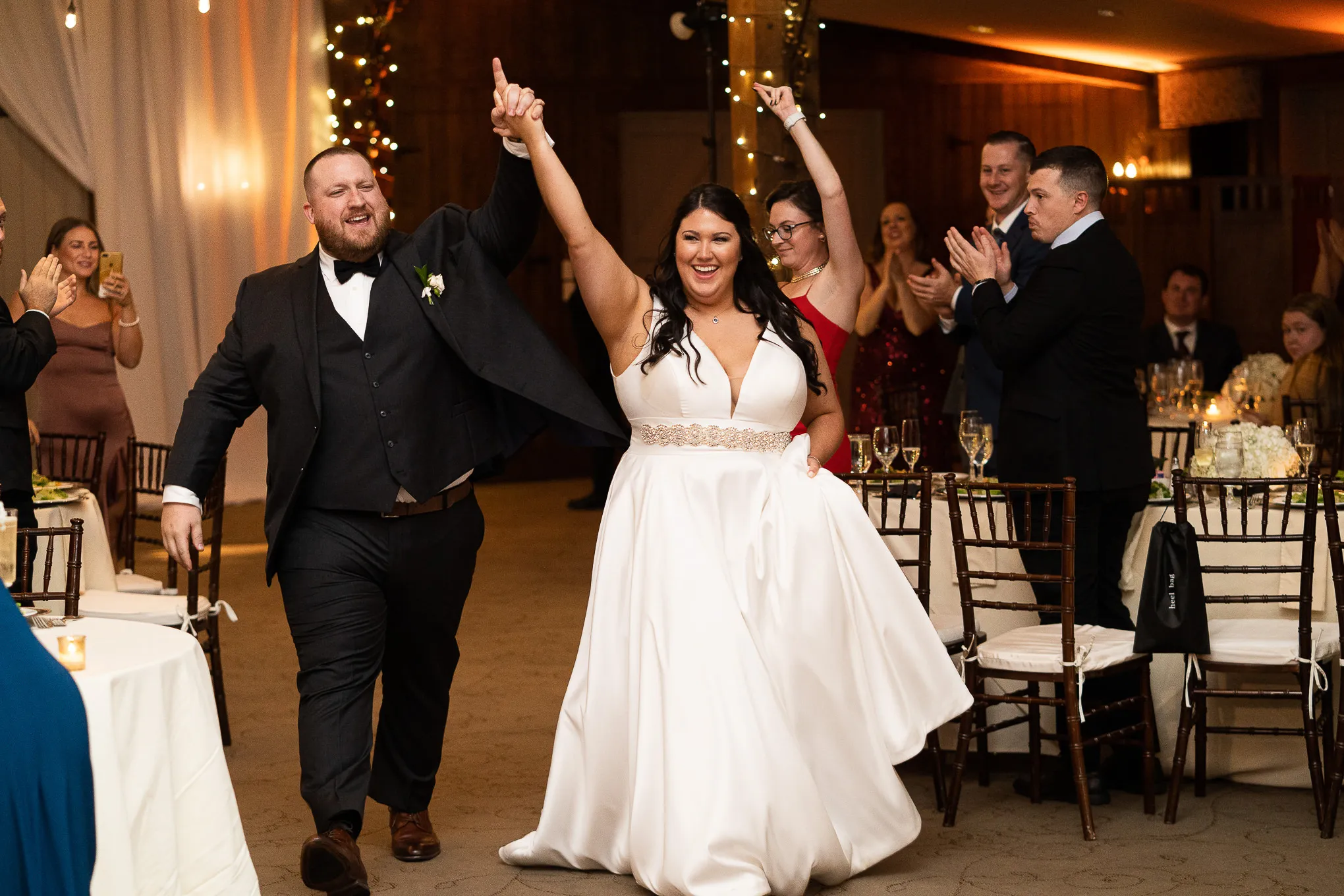 Bride and groom cheering through their grand entrance at the reception