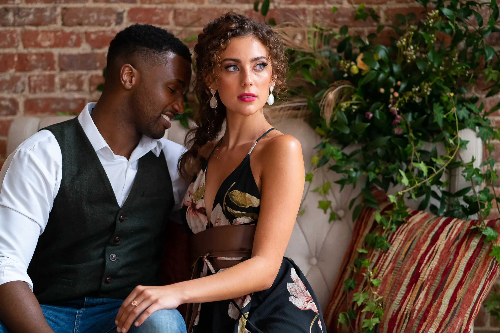 Couple sitting together on a vintage sofa